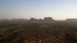 5.5K aerial stock footage of approaching buttes near highway, Monument Valley, Utah, Arizona, twilight Aerial Stock Footage | AX133_115
