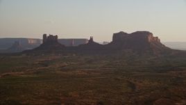 5.5K aerial stock footage of a wide view of buttes and highway in Monument Valley, Utah, Arizona, twilight Aerial Stock Footage | AX133_118E