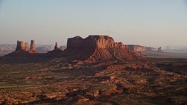 5.5K aerial stock footage of passing Brighams Tomb Butte, Monument Valley, Utah, Arizona, twilight Aerial Stock Footage | AX133_123E
