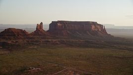 5.5K aerial stock footage of Setting Hen Butte and Eagle Mesa, Monument Valley, Utah, Arizona, twilight Aerial Stock Footage | AX133_125