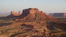 5.5K aerial stock footage of approaching Brighams Tomb Butte, Monument Valley, Utah, Arizona, twilight Aerial Stock Footage | AX133_126E