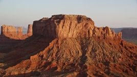 5.5K aerial stock footage of fly over butte, revealing more buttes in Monument Valley, Utah, Arizona, twilight Aerial Stock Footage | AX133_128E