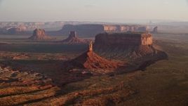 5.5K aerial stock footage of flying by Big Indian Butte, nearby buttes, Monument Valley, Utah, Arizona, twilight Aerial Stock Footage | AX133_131E
