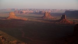 5.5K aerial stock footage of a wide view of several buttes in Monument Valley, Utah, Arizona, twilight Aerial Stock Footage | AX133_137