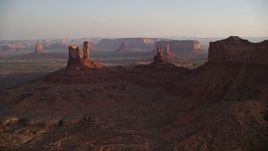 5.5K aerial stock footage of several buttes in Monument Valley, Utah, Arizona, sunset Aerial Stock Footage | AX133_144E
