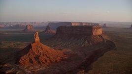 5.5K aerial stock footage of passing buttes and mesas in famous Monument Valley, Utah, Arizona, sunset Aerial Stock Footage | AX133_154