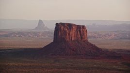 5.5K aerial stock footage of flying by Mitchell Butte, Monument Valley, Utah, Arizona, sunset Aerial Stock Footage | AX133_158E