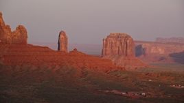 5.5K aerial stock footage of passing by West Bitten Butte, Merrick Butte in Monument Valley, Utah, Arizona, sunset Aerial Stock Footage | AX133_161E