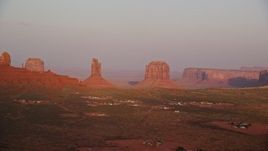 5.5K aerial stock footage flyby buttes in a desert valley, Monument Valley, Utah, Arizona, sunset Aerial Stock Footage | AX133_163