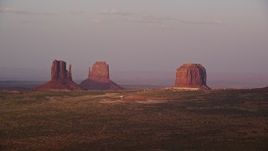 5.5K aerial stock footage of flying by buttes and The View Hotel in famous Monument Valley, Utah, Arizona, sunset Aerial Stock Footage | AX133_169E