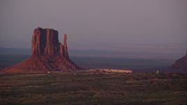5.5K aerial stock footage of lying by Mitten Butte and The View Hotel, Monument Valley, Utah, Arizona, sunset Aerial Stock Footage | AX133_172