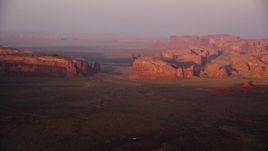 5.5K aerial stock footage of buttes and mesas in Monument Valley, Utah, Arizona, sunset Aerial Stock Footage | AX133_176