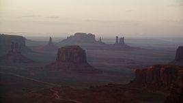 5.5K aerial stock footage of a wide view of Merrick Butte and nearby buttes in Monument Valley, Utah, Arizona, sunset Aerial Stock Footage | AX133_181