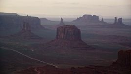 5.5K aerial stock footage of passing West Mitten Butte, Merrick Butte in Monument Valley, Utah, Arizona, sunset Aerial Stock Footage | AX133_182E