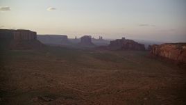 5.5K aerial stock footage of approaching Merrick Butte and Elephant Butte, Monument Valley, Utah, Arizona, sunset Aerial Stock Footage | AX133_188