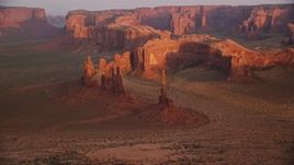 5.5K aerial stock footage of Yei Bi Chei Butte and Totem Pole Butte, Monument Valley, Utah, Arizona, sunset Aerial Stock Footage | AX133_197E
