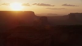 5.5K aerial stock footage of passing by buttes and mesas in Monument Valley, Utah, Arizona, sunset Aerial Stock Footage | AX133_209E