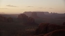 5.5K aerial stock footage of buttes and mesas in Monument Valley, Utah, Arizona, sunset Aerial Stock Footage | AX133_211