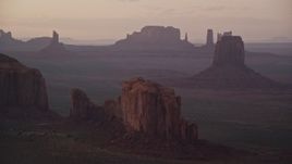 5.5K aerial stock footage of flying by East Mitten Butte, Elephant Butte in Monument Valley, Utah, Arizona, twilight Aerial Stock Footage | AX133_213E