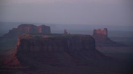 5.5K aerial stock footage of passing by mesas and buttes in Monument Valley, Utah, Arizona, twilight Aerial Stock Footage | AX133_225