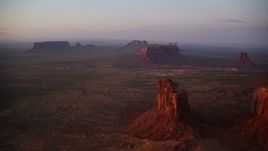 5.5K aerial stock footage view of Sentinel Mesa, buttes in Monument Valley, Utah, Arizona, twilight Aerial Stock Footage | AX133_226E