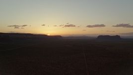 5.5K aerial stock footage of flying by mesas in Monument Valley, Utah, Arizona, twilight Aerial Stock Footage | AX134_001