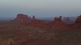 5.5K aerial stock footage of passing by Setting Hen Butte in Monument Valley, Utah, Arizona, twilight Aerial Stock Footage | AX134_011E