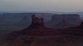 5.5K aerial stock footage of passing by buttes and mesas, Monument Valley, Utah, Arizona, twilight Aerial Stock Footage | AX134_019E