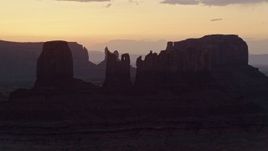 5.5K aerial stock footage of flying by several buttes in Monument Valley, Utah, Arizona, twilight Aerial Stock Footage | AX134_025