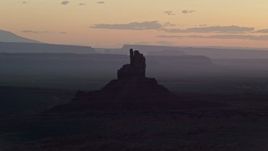 5.5K aerial stock footage of flying by Big Indian Butte and Sentinel Mesa, Monument Valley, Utah, Arizona, twilight Aerial Stock Footage | AX134_026E