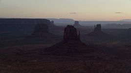 5.5K aerial stock footage of a view of several buttes in Monument Valley, Utah, Arizona, twilight Aerial Stock Footage | AX134_029E