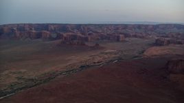 5.5K aerial stock footage of flying toward buttes, rock formations in Monument Valley, Utah, Arizona, twilight Aerial Stock Footage | AX134_034E