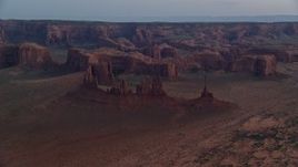 5.5K aerial stock footage of buttes and rock formations in Monument Valley, Utah, Arizona, twilight Aerial Stock Footage | AX134_036