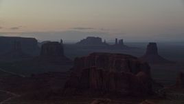 5.5K aerial stock footage wide view of desert buttes in famous Monument Valley, Utah, Arizona, twilight Aerial Stock Footage | AX134_044E