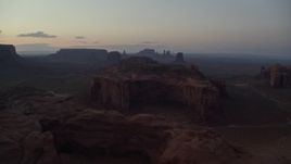 5.5K aerial stock footage of flying by several buttes and mesas, Monument Valley, Utah, Arizona, twilight Aerial Stock Footage | AX134_046E