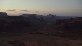 5.5K aerial stock footage of desert buttes and mesas, Monument Valley, Utah, Arizona, twilight Aerial Stock Footage | AX134_048E