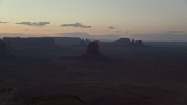5.5K aerial stock footage of flying by East Mitten Butte, mesas, and buttes in Monument Valley, Utah, Arizona, twilight Aerial Stock Footage | AX134_052
