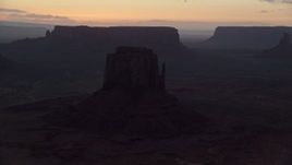 5.5K aerial stock footage of flying by several buttes in thick haze, Monument Valley, Utah, Arizona, twilight Aerial Stock Footage | AX134_056E