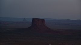 5.5K aerial stock footage of passing by Mitchell Butte in Monument Valley, Utah, Arizona, twilight Aerial Stock Footage | AX134_066E