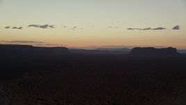 5.5K aerial stock footage of flying by Oljeto Mesa and Train Rock at Navajo Nation Reservation, Arizona, Utah, twilight Aerial Stock Footage | AX134_072