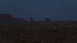 5.5K aerial stock footage of flying by small town and buttes in Monument Valley, Utah, Arizona, night Aerial Stock Footage | AX134_074E