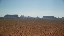 5.5K aerial stock footage of flying by mesas and buttes across desert, Monument Valley, Utah, Arizona Aerial Stock Footage | AX135_001E
