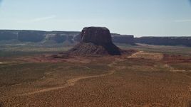 5.5K aerial stock footage of passing by Mitchell Butte and desert, Monument Valley, Utah, Arizona Aerial Stock Footage | AX135_005E