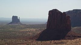 5.5K aerial stock footage of flying by buttes, mesas, and The View Hotel, Monument Valley, Utah, Arizona Aerial Stock Footage | AX135_010E