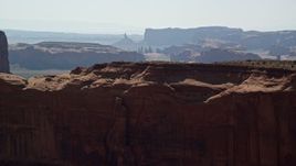 5.5K aerial stock footage fly over Mitchell Mesa, and approach mesas, buttes in Monument Valley, Utah, Arizona Aerial Stock Footage | AX135_012E