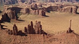 5.5K aerial stock footage of flying by Yei Bi Chei Butte and Totem Pole Butte, Monument Valley, Utah, Arizona Aerial Stock Footage | AX135_025