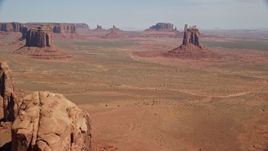 5.5K aerial stock footage of approaching several buttes from Cly Butte in Monument Valley, Utah, Arizona Aerial Stock Footage | AX135_031