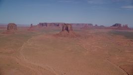 5.5K aerial stock footage of a wide view of several buttes and mesas in a desert valley, Monument Valley, Utah, Arizona Aerial Stock Footage | AX135_035