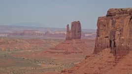 5.5K aerial stock footage of passing by East Mitten Butte, reveal West Mitten Butte, Monument Valley, Utah, Arizona Aerial Stock Footage | AX135_037E