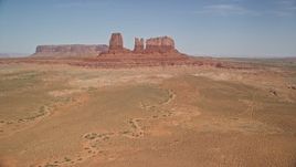 5.5K aerial stock footage of an approach to buttes in a desert valley, Monument Valley, Utah, Arizona Aerial Stock Footage | AX135_043E